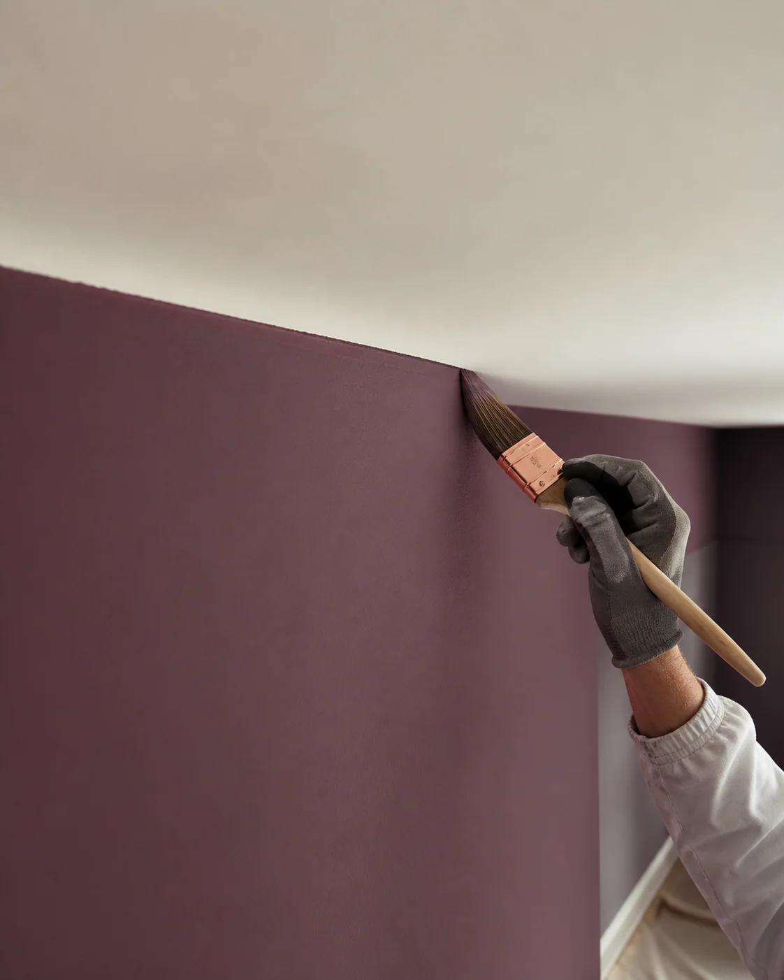 Precise brushwork on a coloured interior wall